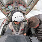 Sokol Test Pilot Sergey Kara checks to make sure Chang is prepared for his high-altitude flight in the MiG-29. Chang is an Intel prizewinner from South Korea.