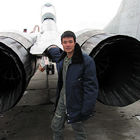 Mai from Vietnam stands behind the MiG-29 that carried him to the edge of space.